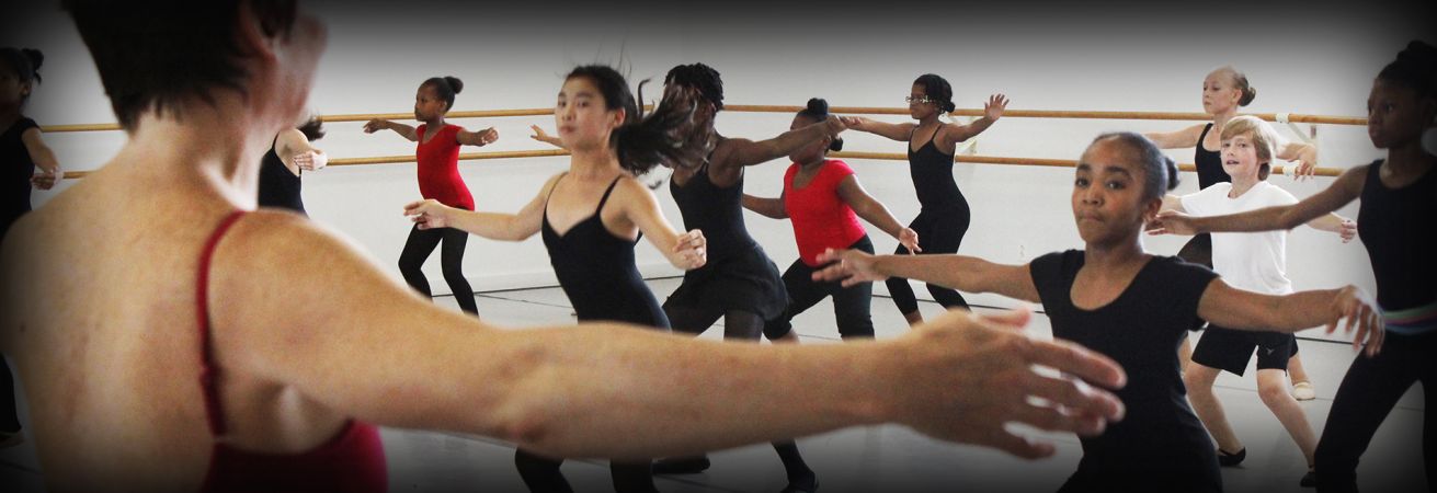 Group of teens with their arms out to the side dressed in red and black.
